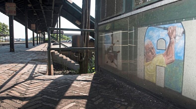 In the "A" of Latrobe, spelled out at the Latrobe train station, Arnold Palmer swings his club on Thursday, Sept 21, 2017 in Latrobe. (Haley Nelson/Pittsburgh Post-Gazette/TNS)