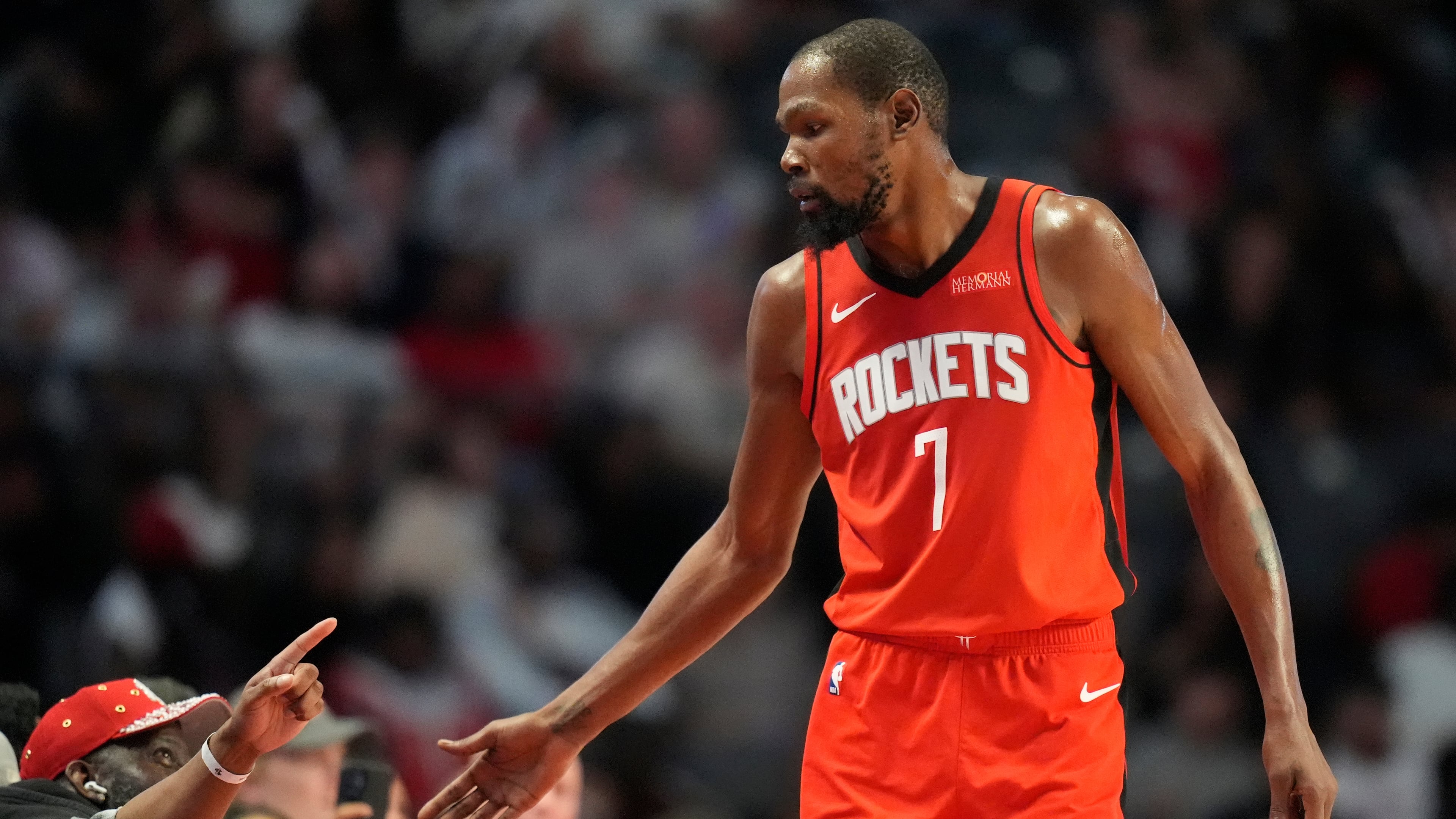 Houston Rockets forward Kevin Durant (7) greets fans during the second half of an NBA preseason basketball game against the New Orleans Pelicans, Tuesday, Oct. 14, 2025, in Birmingham, Ala. (AP Photo/Mike Stewart)