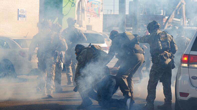 FILE - Federal immigration enforcement agents detain a protester in the Little Village neighborhood of Chicago on Oct. 23, 2025. (Anthony Vazquez/Chicago Sun-Times via AP, File)