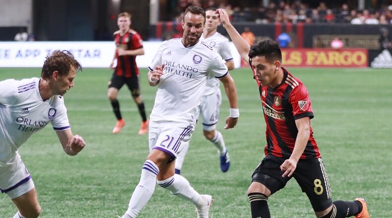 June 30, 2018 Atlanta: Atlanta United Ezequiel Barco works against two Orlando City defenders during the second half in a MLS soccer match on Saturday, June 30, 2018, in Atlanta.     Curtis Compton/ccompton@ajc.com