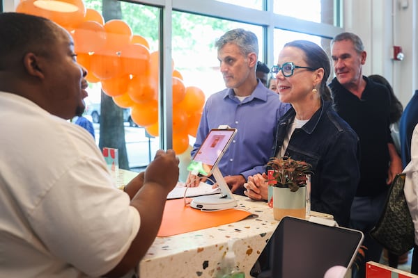 Store manager Antonio Aaron helps customer Amanda Thompson with an order during the Edibles.com grand opening on Thursday, April 9, 2026, in Atlanta. (Abbey Cutrer/AJC)
