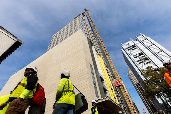 People gather for the topping out ceremony for the 1072 W Peachtree St. building in Atlanta on Friday, November 7, 2025. The mixed use tower will be Atlanta’s fifth tallest building. (Arvin Temkar/AJC)