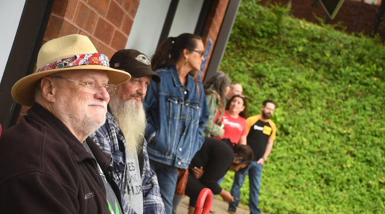 In this file photo, Ken Moore, of Woodstock, (left) and Les Wilson, of Powder Springs, (center) wait for Trulieve Medical Marijuana Dispensary to open up in Marietta on Friday April 28, 2023. Georgia's first medical marijuana dispensaries opened today in Marietta and in Macon. (Photo by Rebecca Breyer/freelance photographer)