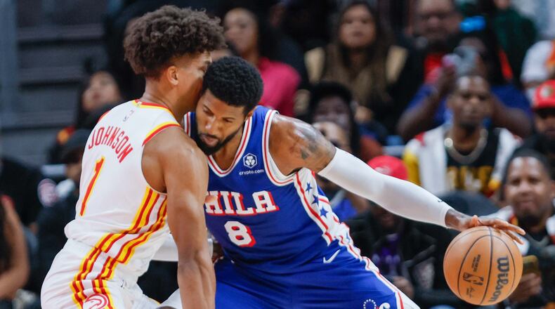 Atlanta Hawks forward Jalen Johnson (1) battles for the ball against Philadelphia 76ers forward Paul George (8) during the second half at State Farm Arena during an NBA exhibition game on Monday, October 14, 2024, in Atlanta.
(Miguel Martinez/ AJC)