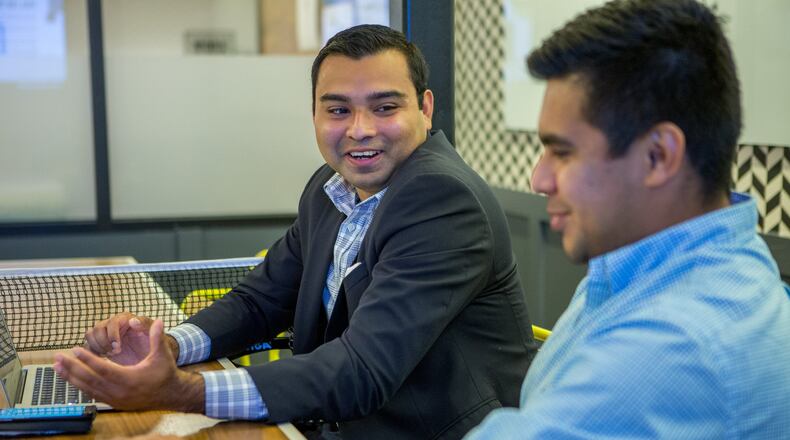 Jaime Rangel (left), a recipient of Deferred Action for Childhood Arrivals, works as an organizing intern with Sam Aguilar at Fwd.Us in Atlanta. (Photo by Phil Skinner)