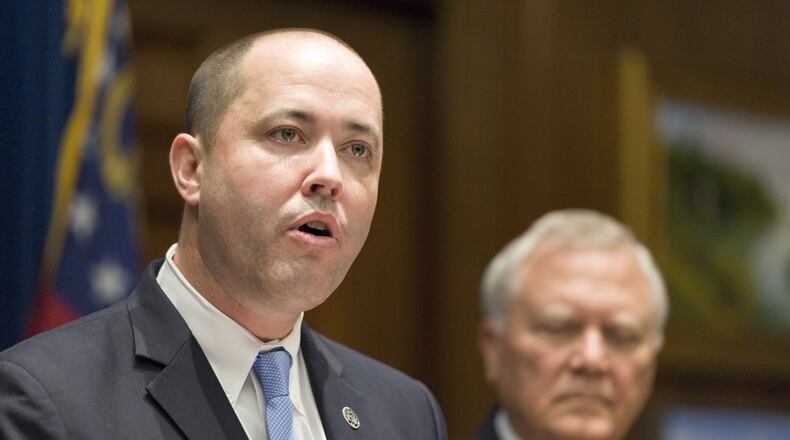 Chris Carr (left), shown addressing reporters in 2016 upon his appointment by Gov. Nathan Deal to serve as Georgia attorney general. AJC FILE PHOTO