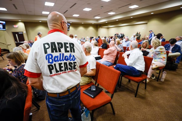 A paper ballot supporter attends a State Election Board meeting at Dawson County Government Center on Wednesday, April 25, 2026. (Miguel Martinez/AJC)