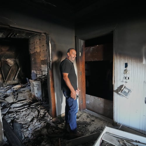 Resident Samih Haidar reacts as he inspects his burned apartment damaged in Israeli strikes in the southern port city of Tyre, Lebanon, Thursday, June 18, 2026. (AP Photo/Hassan Ammar)
