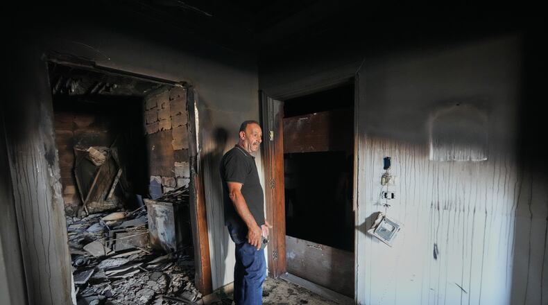 Resident Samih Haidar reacts as he inspects his burned apartment damaged in Israeli strikes in the southern port city of Tyre, Lebanon, Thursday, June 18, 2026. (AP Photo/Hassan Ammar)