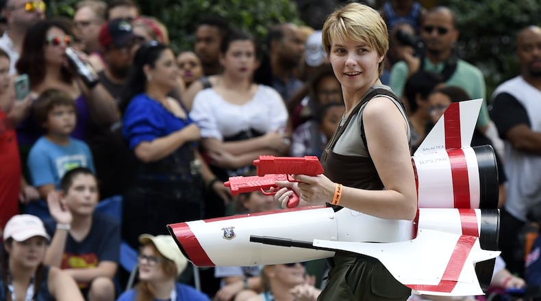 9/1/18 - Atlanta - A cosplayer dressed as Kara Thrace, the Viper pilot in the television series “Battlestar Galactica,” walks down Peachtree Street with her Viper at the annual Dragon Con Parade on Saturday, September 1. JENNA EASON/JENNA.EASON@COXINC.COM