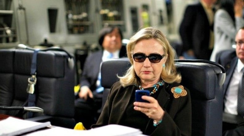 Hillary Clinton checks her email. Associated Press