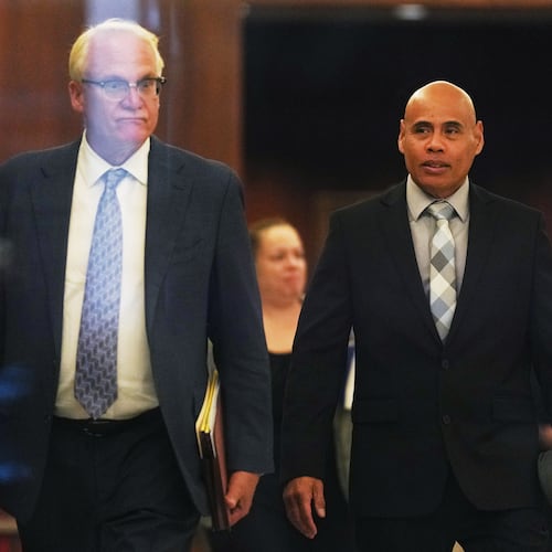 Christian Castro, right, an immigration officer who is accused of shooting a Venezuelan man during the immigration crackdown in Minneapolis early this year and lying to investigators about what happened, leaves with his attorney Daniel Gerdts, left, after a hearing at the Warren E. Burger Federal Building, Friday, Sept. 18, 2026, in St. Paul, Minn. (AP Photo/Ellen Schmidt)