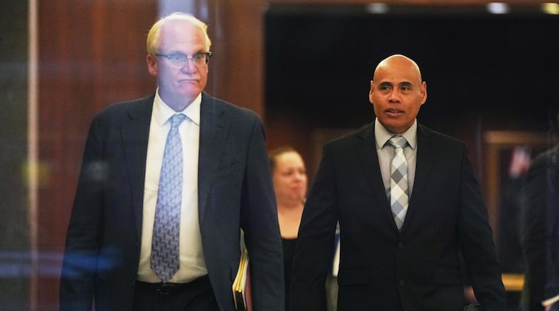 Christian Castro, right, an immigration officer who is accused of shooting a Venezuelan man during the immigration crackdown in Minneapolis early this year and lying to investigators about what happened, leaves with his attorney Daniel Gerdts, left, after a hearing at the Warren E. Burger Federal Building, Friday, Sept. 18, 2026, in St. Paul, Minn. (AP Photo/Ellen Schmidt)