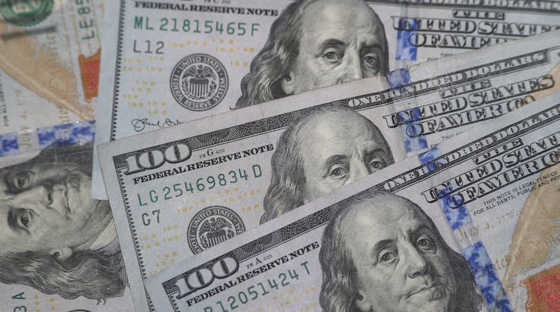 This Jan. 22, 2020, file photo shows the likeness of Benjamin Franklin on $100 bills. Many Americans are struggling financially due to the coronavirus. Recent federal efforts are aimed at easing credit for businesses and providing financial relief to Americans. (AP Photo/L.M. Otero, File)