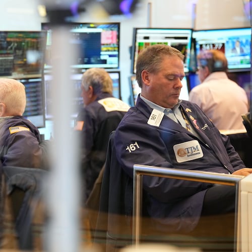 Traders, including Thomas McCauley, second from right, work on the floor at the New York Stock Exchange in New York, Wednesday, Oct. 29, 2025. (AP Photo/Seth Wenig)