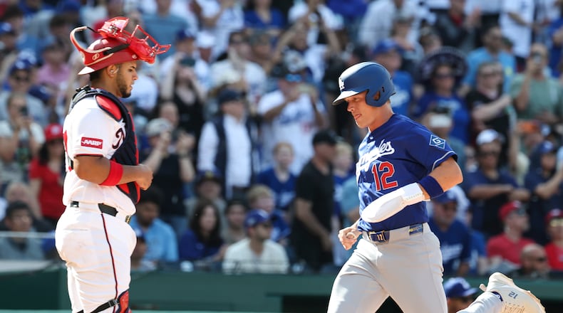 Los Angeles Dodgers' Alex Call (12) scores a run on a sacrifice fly hit by Shohei Ohtani off Washington Nationals pitcher Andre Granillo (not shown) during the ninth inning of a baseball game, Friday, April 3, 2026, in Washington. (AP Photo/Terrance Williams)