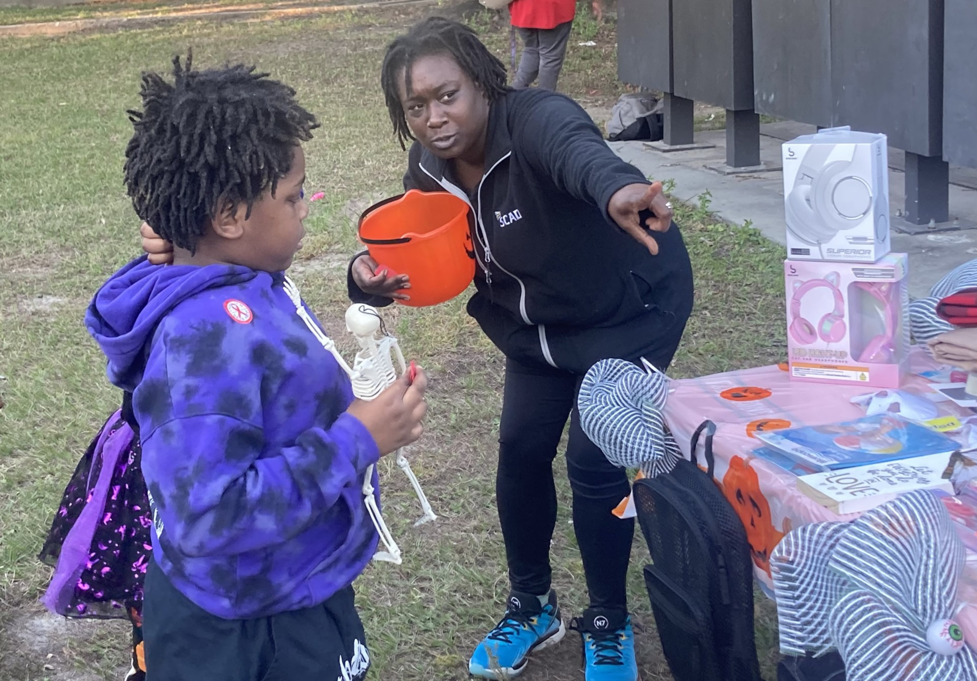 Kevina Atkinson draws tickets in a toy raffle during the Yamacraw Village Halloween celebration on Oct. 31, 2025. (Adam Van Brimmer/AJC)