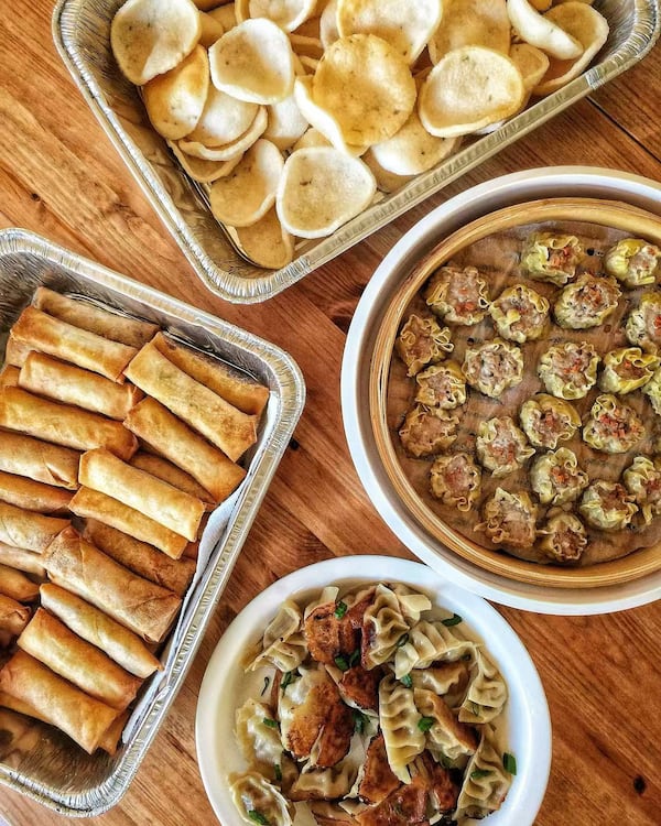 Four serving dishes show spring rolls, shrimp chips, dumplings and pot stickers from Soupbelly.