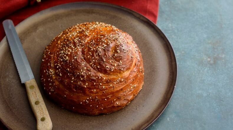 A loaf of Sephardic challah, in New York, Nov. 22, 2015. The braided, sweet challah familiar to Americans comes from Eastern European baking tradition; but in the Middle East and North Africa, where spicy cuisine reigns supreme and both eggs and sugar are scarce, Sabbath breads are made with olive oil and often make use of seeds and nuts.