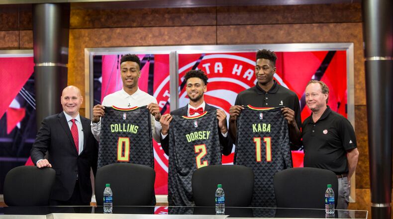 Atlanta Hawks General Manager, Travis Schlenk (far left), and Head Coach Mike Budenholzer (far right), stand on the outside of rookies: John Collins (left), Tyler Dorsey (middle) and Alpha Kaba (right).  Chad Rhym/ Chad.Rhym@ajc.com