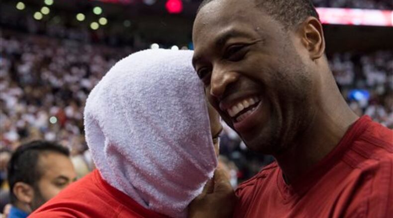 Miami Heat's Dwyane Wade, right, congratulates Toronto Raptors' Kyle Lowry following Game 7 of the NBA basketball Eastern Conference semifinals in Toronto, Sunday, May 15, 2016. The Raptors won 116-89. (Frank Gunn/The Canadian Press via AP) MANDATORY CREDIT