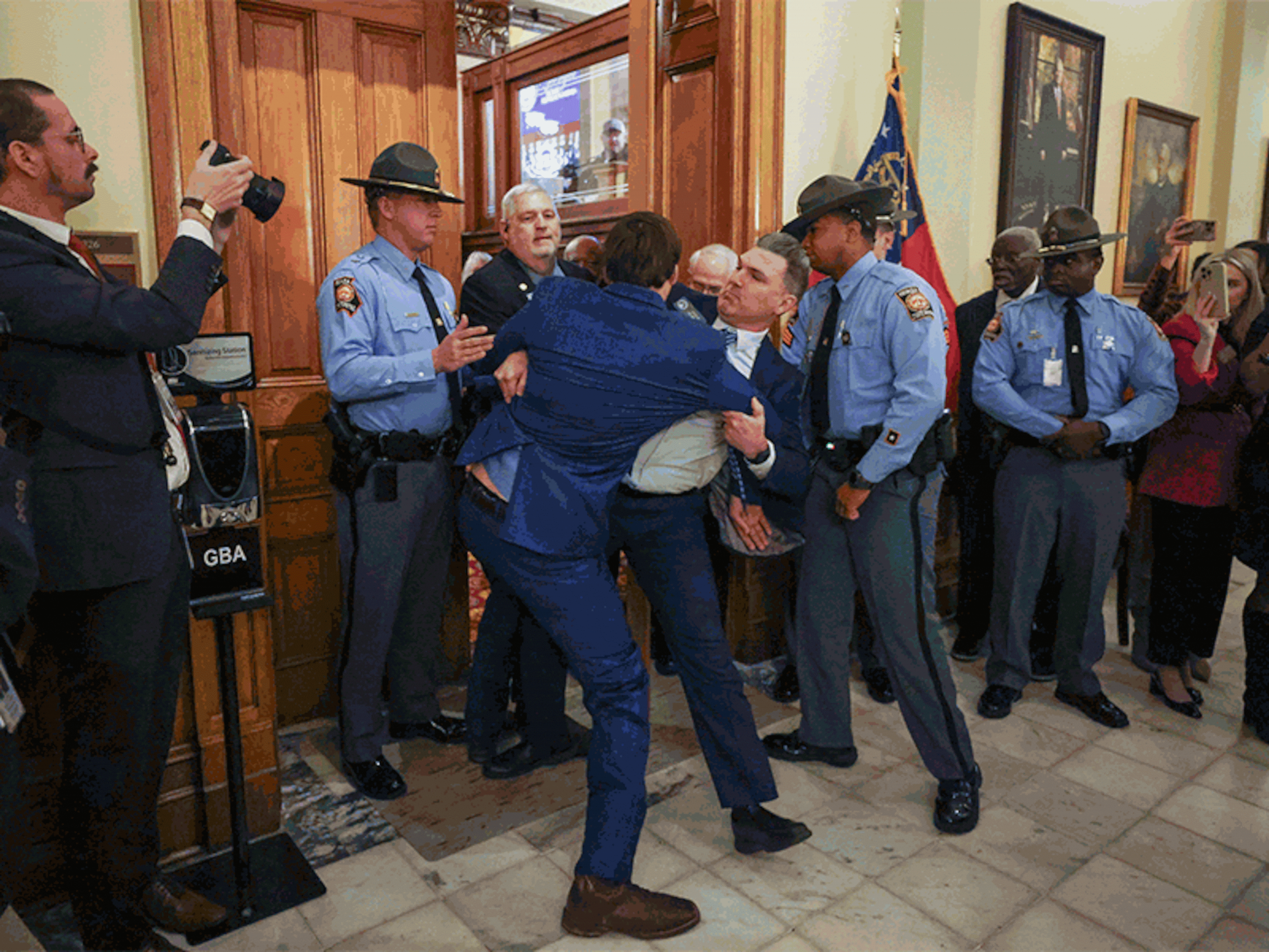 Sen. Colton Moore, R-Trenton, falls to the ground after scuffling with a staff member as he attempts to enter the state House of Representatives for the State of the State address Jan. 16. (Jason Getz/AJC)