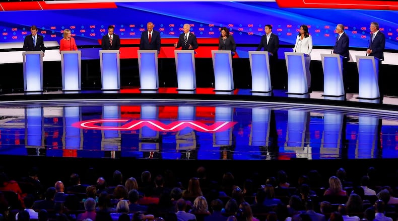 From left, Sen. Michael Bennet, D-Colo., Sen. Kirsten Gillibrand, D-N.Y., former Housing and Urban Development Secretary Julian Castro, Sen. Cory Booker, D-N.J., former Vice President Joe Biden, Sen. Kamala Harris, D-Calif., Andrew Yang, Rep. Tulsi Gabbard, D-Hawaii, Washington Gov. Jay Inslee and New York City Mayor Bill de Blasio participate in the second of two Democratic presidential primary debates hosted by CNN Wednesday, July 31, 2019, in the Fox Theatre in Detroit. (AP Photo/Paul Sancya)