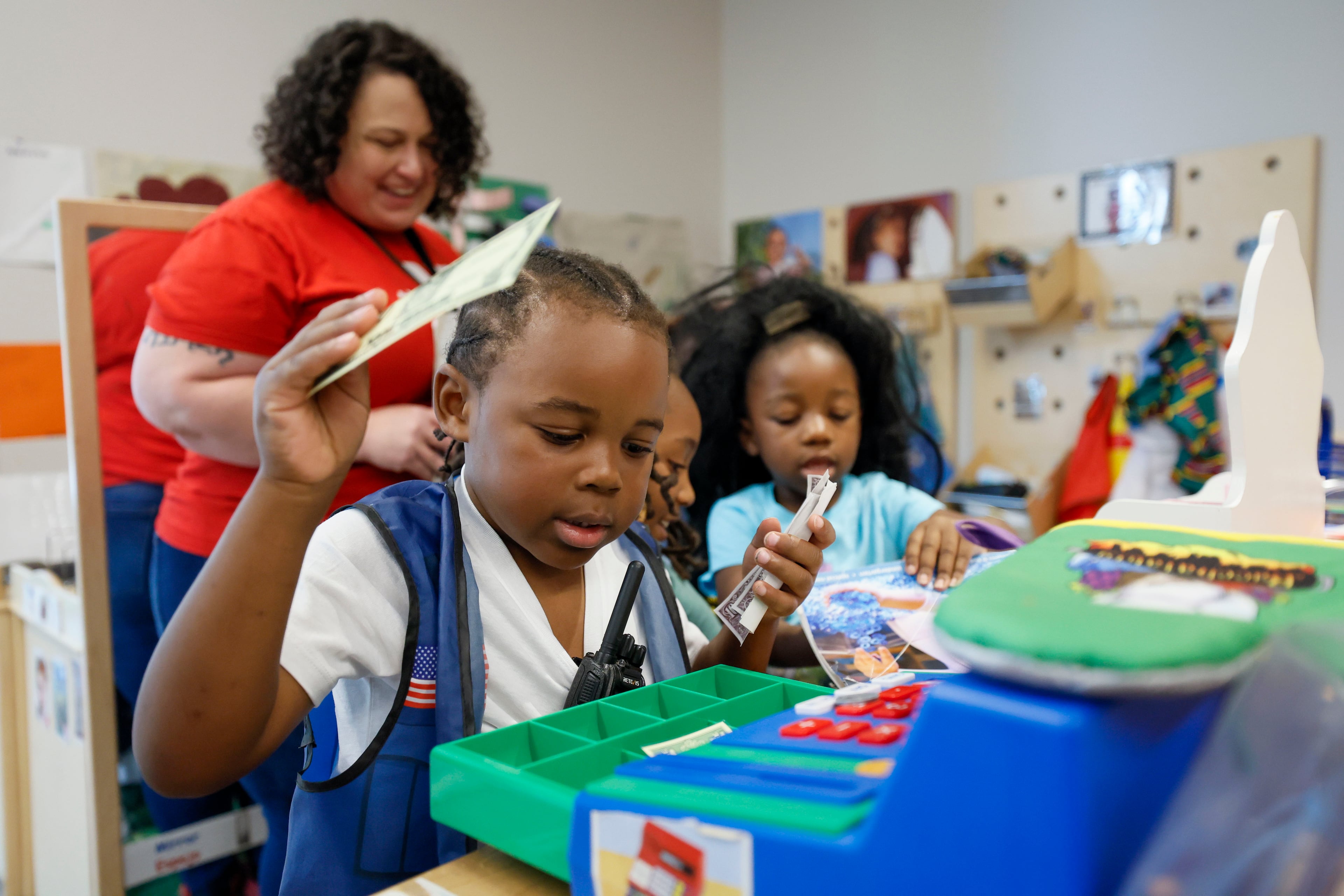 Children in the Head Start program engage in indoor activities with lead teacher Genesis Lavanway at the Arthur M. Blank Early Learning Center, Atlanta, where providers, parents and advocates celebrated the 60th birthday of the federal Head Start program on Monday. (Miguel Martinez/AJC)