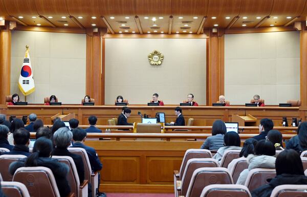 FILE - South Korea's Constitutional Court's judges, from left, Chung Kye-sun, Kim Bok-hyeong, Jung Jung-mi, Lee Mi-son, acting Chief Justice Moon Hyung-bae, Kim Hyung-du, Cheong Hyung-sik and Cho Han-chang sit for the first formal hearing of a trial on the validity of President Yoon Suk Yeol's impeachment by the National Assembly at the constitutional court of Korea in Seoul, South Korea, on Jan. 14, 2025. (Kim Min-Hee/Pool Photo via AP, File)