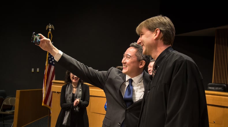 Ben Ku (L) takes a selfie with Gwinnett Country Probate Judge Christopher A. Ballar during Ku’s swearing-in ceremony at the Gwinnett Justice and Administration Center in Lawrenceville GA Friday 21, 2018. STEVE SCHAEFER / SPECIAL TO THE AJC