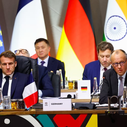 France's President Emmanuel Macron and Germany's Chancellor Friedrich Merz attend a plenary session on the opening day of the G20 Summit at the Nasrec Expo Centre, in Johannesburg, South Africa, Saturday, Nov. 22, 2025. (Thomas Mukoya/Pool Photo via AP)