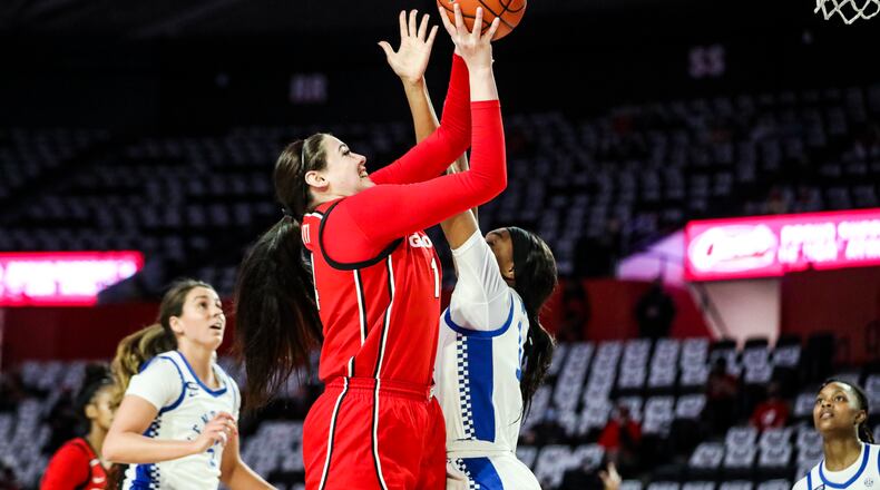 Georgia center Jenna Staiti (14) goes up and over to score against Kentucky in their last game at Stegeman Coliseum in Athens Thursday, Feb. 25, 2021. (Photo by Tony Walsh/UGA Athletics)