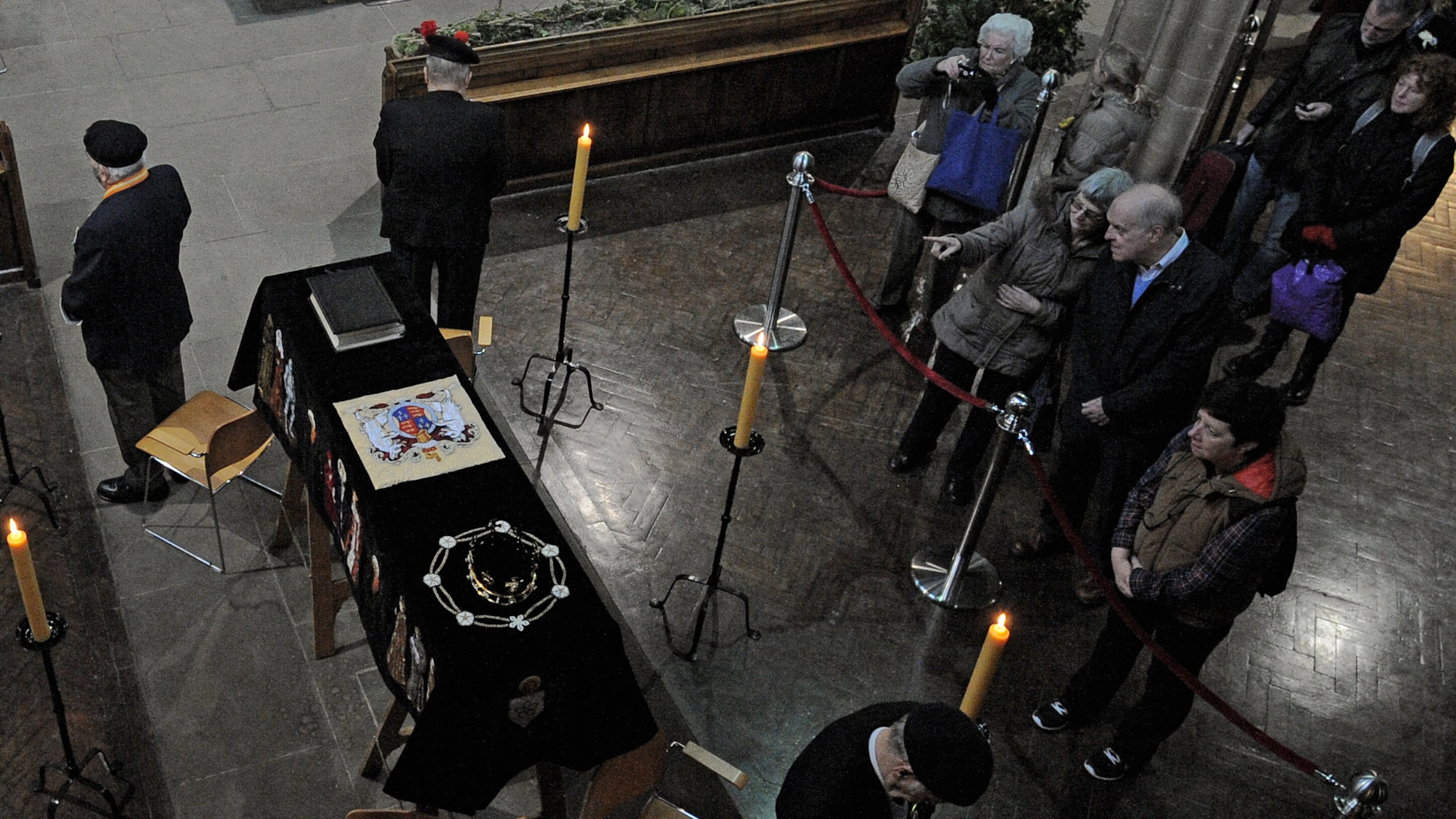 FILE - In this Monday, March 23, 2015 file photo, members of the public view the coffin of Richard III as it lies in repose inside Leicester Cathedral, Leicester, England. (AP Photo/Rui Vieira, File)