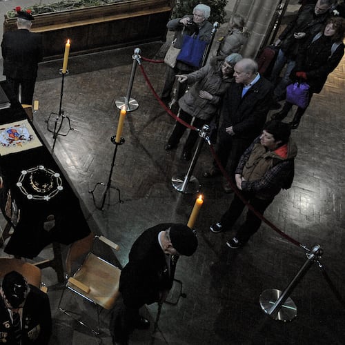FILE - In this Monday, March 23, 2015 file photo, members of the public view the coffin of Richard III as it lies in repose inside Leicester Cathedral, Leicester, England. (AP Photo/Rui Vieira, File)