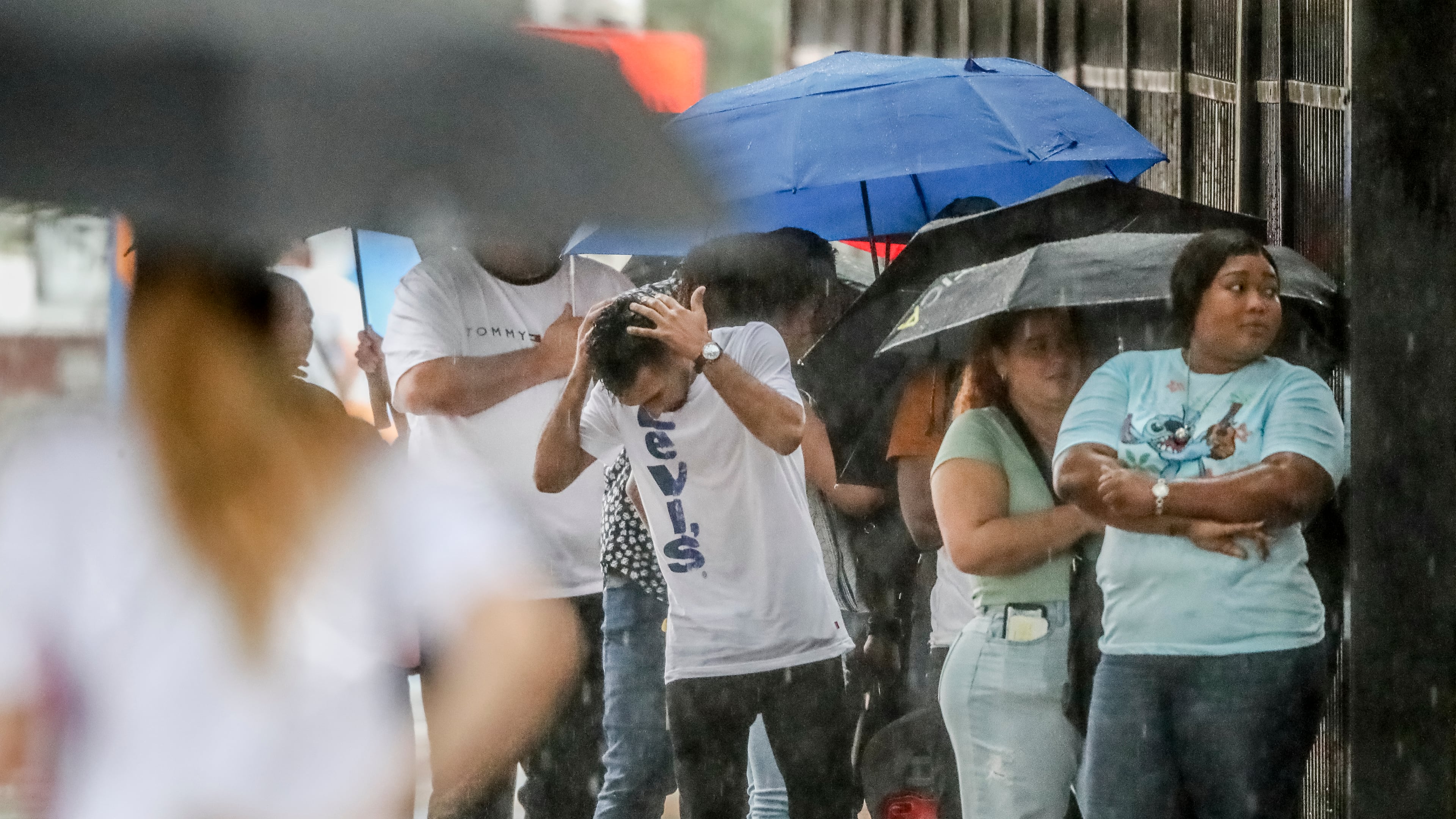 People waited in line in the rain outside Atlanta Immigration Court at 180 Ted Turner Drive in downtown Atlanta. (John Spink/AJC 2019)