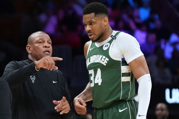 Milwaukee Bucks head coach Doc Rivers, left, talk with forward Giannis Antetokounmpo (34) during the second half of an NBA basketball game against the Miami Heat, Saturday, April 5, 2025, in Miami. (AP Photo/Lynne Sladky)
