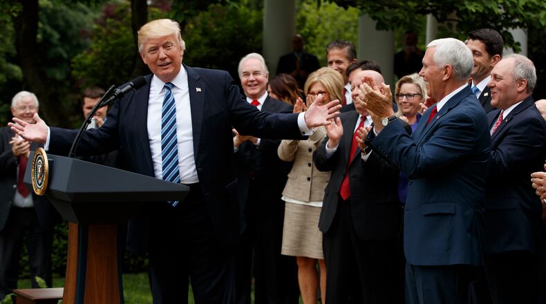 President Donald Trump, accompanied by GOP House members, speaks in the Rose Garden of the White House in Washington, Thursday, May 4, 2017, after the House pushed through a health care bill. (AP Photo/Evan Vucci)