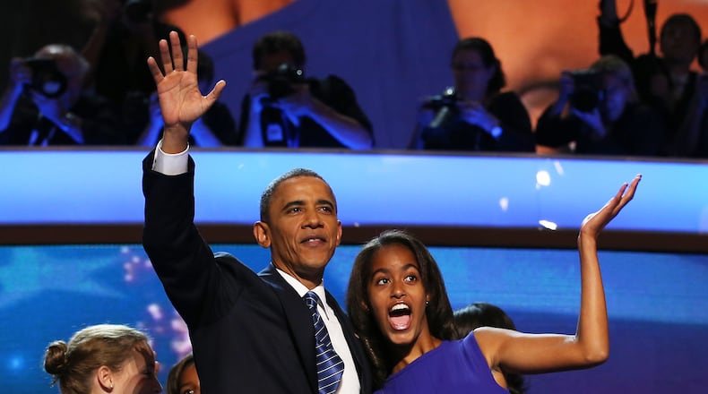 CHARLOTTE, NC - SEPTEMBER 06: Democratic presidential candidate, U.S. President Barack Obama waves on stage with Malia Obama after accepting the nomination during the final day of the Democratic National Convention at Time Warner Cable Arena on September 6, 2012 in Charlotte, North Carolina. The DNC, which concludes today, nominated U.S. President Barack Obama as the Democratic presidential candidate. (Photo by Chip Somodevilla/Getty Images)