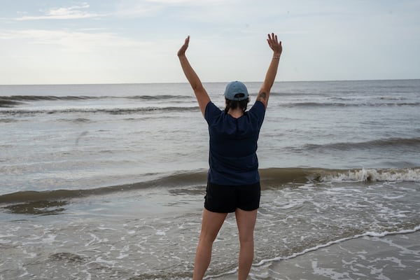 Lydia McDonald, a hospital technician at the Georgia Sea Turtle Center, signaled success after Earl Grey was returned to the Atlantic Ocean on Jekyll Island Thursday.  (Courtesy of Jekyll Island Authority)