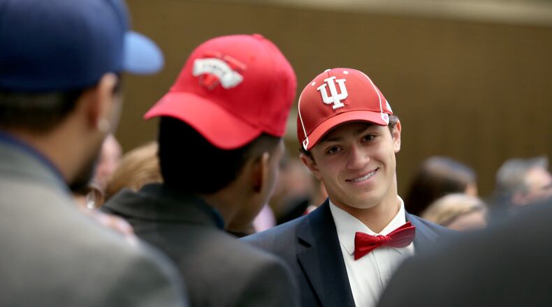 Alpharetta’s Austin King, committed to Indiana University on Feb. 4, 2015. Here, he talks to his teammates during the Signing Day festivities at the College Football Hall of Fame. (AJC / JASON GETZ)