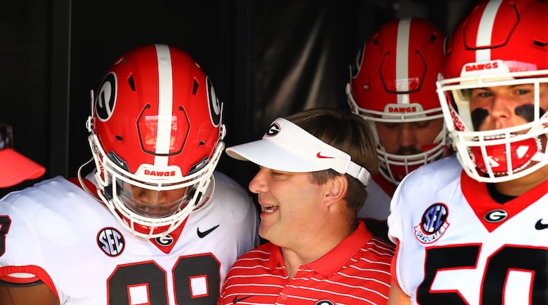 Georgia coach Kirby Smart confers with tight end Jesse Sanders while taking the field to play South Carolina in a NCAA college football game on Saturday, Sept. 17, 2022, in Columbia.   “Curtis Compton / Curtis Compton@ajc.com