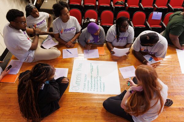 Residents work in groups to break down what they expect to accomplish within the five phases of the IGNITE Teacher Residency Program at Stone Mountain High School on Thursday. July 23, 2026. (Estela Muñoz/AJC)