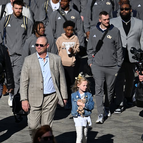 Georgia Tech head coach Brent Key with his daughter Harper arrives before the start of the Georgia Tech vs Georgia football game at Mercedes-Benz Stadium, Friday, November 28, 2025 in Atlanta. (Hyosub Shin / AJC)