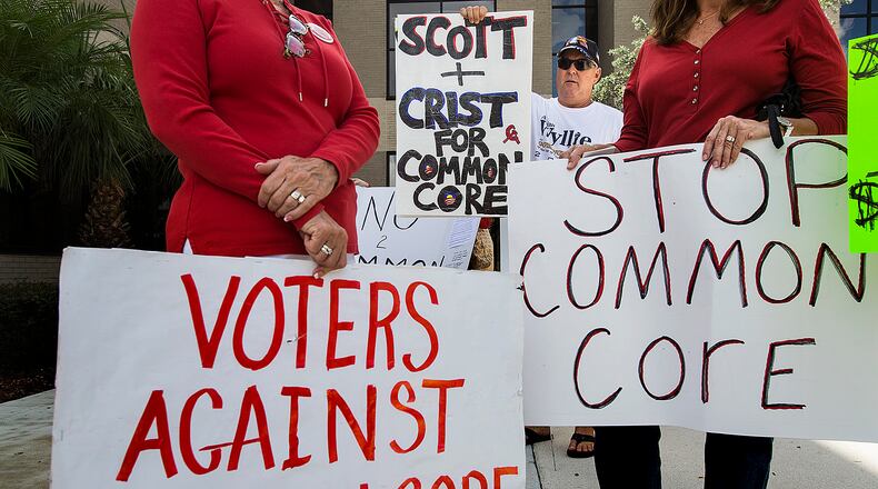 Dan Ray, holds up a sign with other opponents of Common Core outside the Palm Beach County School Board offices before a meeting by the 11-county group,"The Greater Consortium of School Board Members," September 19, 2014, in West Palm Beach. (Greg Lovett / The Palm Beach Post) The battle against Common Core never gained the traction in Georgia that it did in other states. (AJC File.)