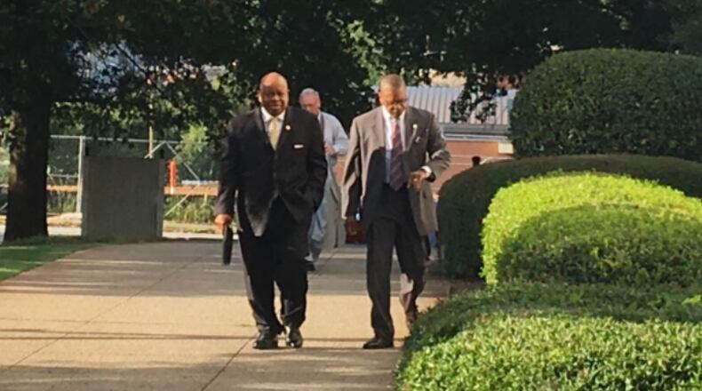 Former DeKalb County Commissioner Stan Watson, left, walks toward the county courthouse before his arraignment Tuesday, Aug. 1, 2017. Watson pleaded not guilty. MARK NIESSE / MARK.NIESSE@AJC.COM