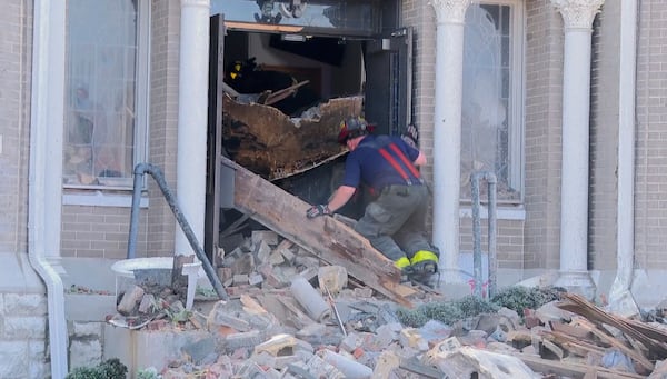 A firefighter enters a damaged building after a severe storm passed the area on Saturday, May 17, 2025 in St. Louis, Mo. ( KMOV via AP)