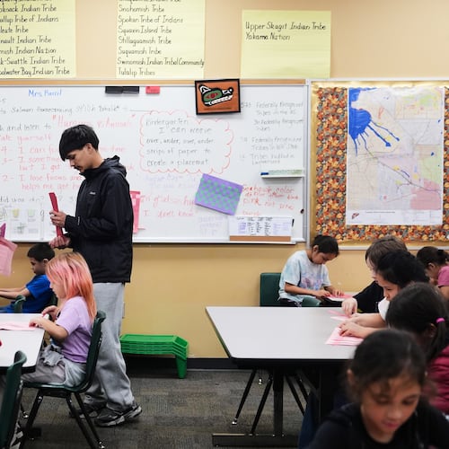 Chief Leschi Schools senior Gerald Dillon, 18, helps during a weaving exercise in a culture class for second graders as he serves as a teaching assistant through the school's career and technical education program, Wednesday, March 18, 2026, at Chief Leschi Schools in Puyallup, Wash. (AP Photo/Lindsey Wasson)