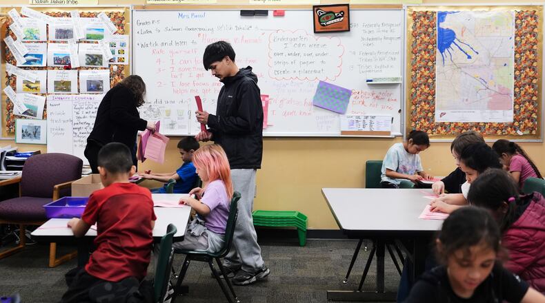 Chief Leschi Schools senior Gerald Dillon, 18, helps during a weaving exercise in a culture class for second graders as he serves as a teaching assistant through the school's career and technical education program, Wednesday, March 18, 2026, at Chief Leschi Schools in Puyallup, Wash. (AP Photo/Lindsey Wasson)