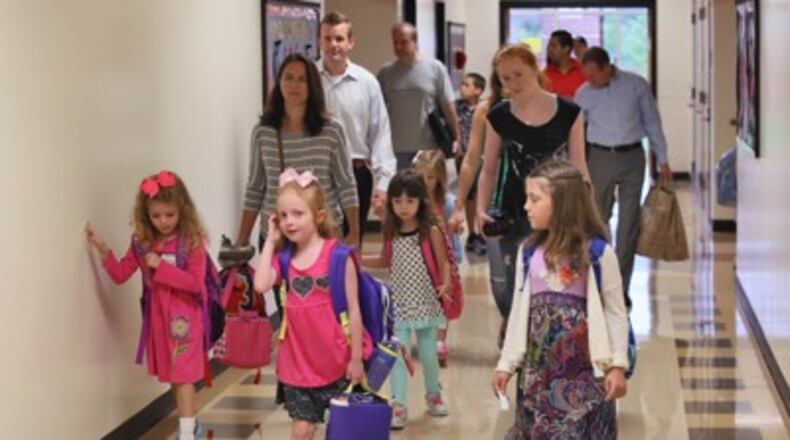 Kindergarten students head to class at a Fulton County elementary school. Parents wishing to register their prospective kindergartners for next fall will be able to do so on two days next month. (AJC file)