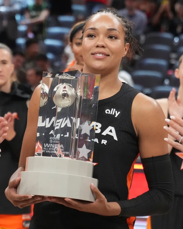Minnesota Lynx's Napheesa Collier holds the MVP trophy following a WNBA All-Star basketball game against Team Clark, Saturday, July 19, 2025, in Indianapolis. (AP Photo/Michael Conroy)